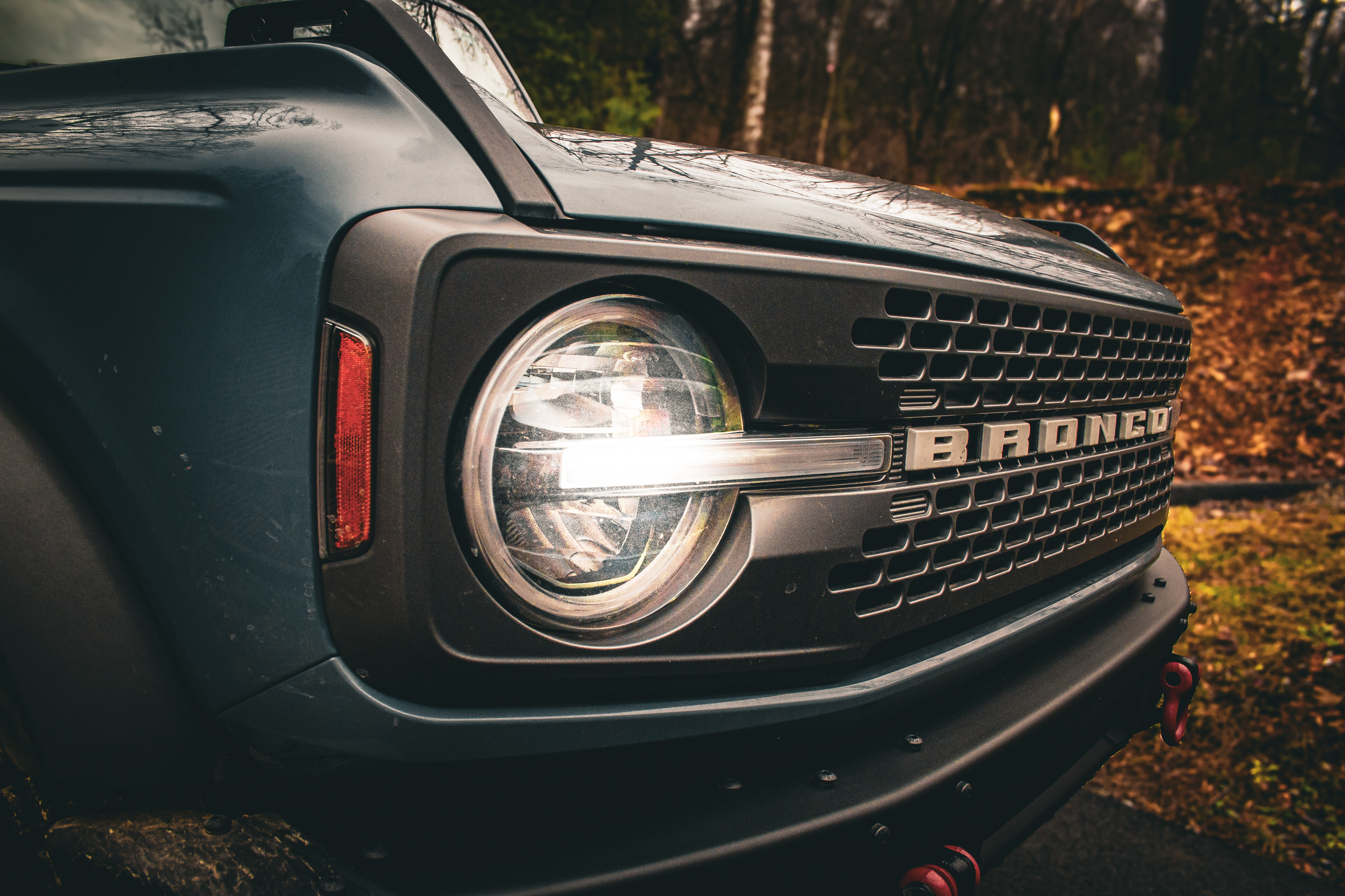 Car front grille detail at sunset